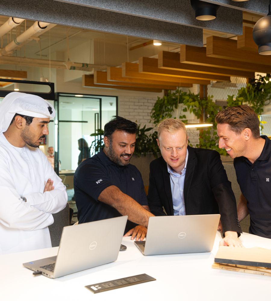 interior fit outs abu dhabi people having a meeting and looking at laptop screens