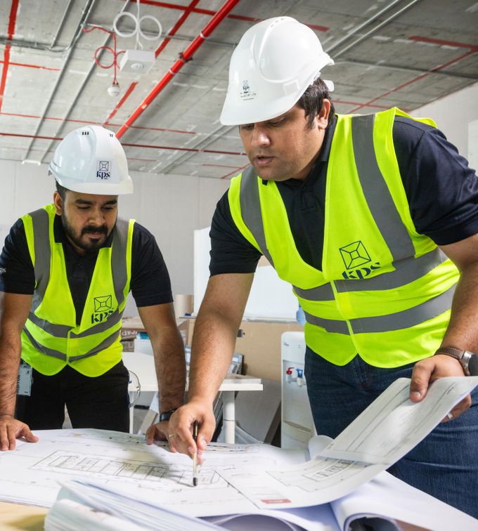 uae fit outs people working and inspecting diagrams